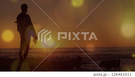 Image of light spots over caucasian man at seaside Image of light spots over caucasian man at seaside 126481011