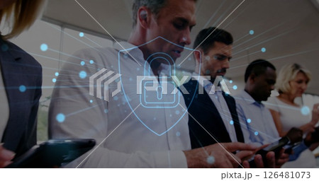Image of shield with padlock over diverse colleagues using smartphones 126481073