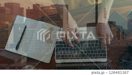 Image of hands of caucasian businesswoman using laptop and taking notes over cityscape 126481167
