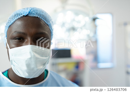Healthcare professional wearing surgical mask and cap in hospital operating room, copy space 126483706