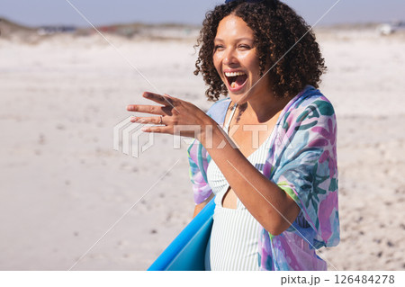 Laughing woman holding surfboard on sunny beach, enjoying summer day, copy space Laughing woman holding surfboard on sunny beach, enjoying summer day, copy space 126484278