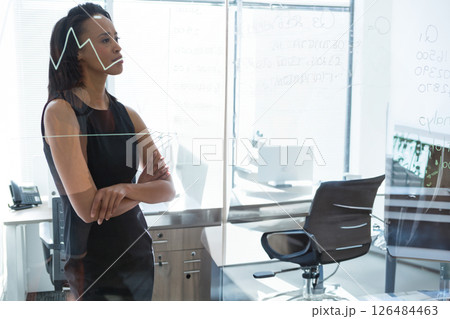 Businesswoman analyzing data on glass board in modern office, deep in thought, copy space 126484463