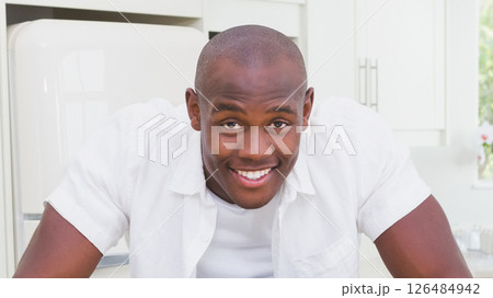 In kitchen, man smiling and relaxing, enjoying day at home 126484942