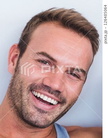 Smiling man enjoying relaxed moment at home, showing happiness and positivity 126485064