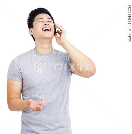 Laughing Asian man talking on smartphone, having fun conversation at home Laughing Asian man talking on smartphone, having fun conversation at home 126485258