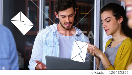 Image of a caucasian man discussing with his female coworker in the office with message icons Image of a caucasian man discussing with his female coworker in the office with message icons 126485892