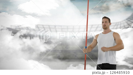 Athlete holding javelin in stadium, preparing for throw with determination 126485910