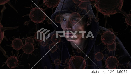 Hooded man surrounded by virus illustrations, contemplating in dark environment 126486071