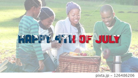African American family enjoying picnic in park celebrating Fourth of July together African American family enjoying picnic in park celebrating Fourth of July together 126486206