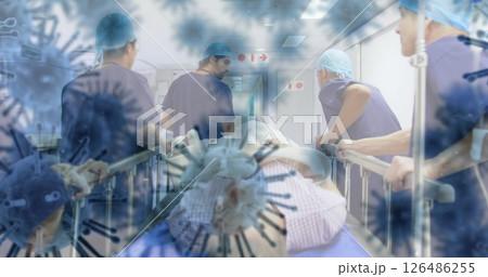 Medical team in hospital corridor transporting patient on stretcher during pandemic Medical team in hospital corridor transporting patient on stretcher during pandemic 126486255