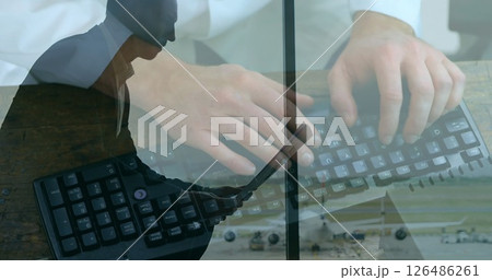 Business professional typing on keyboard and using laptop in modern office Business professional typing on keyboard and using laptop in modern office 126486261