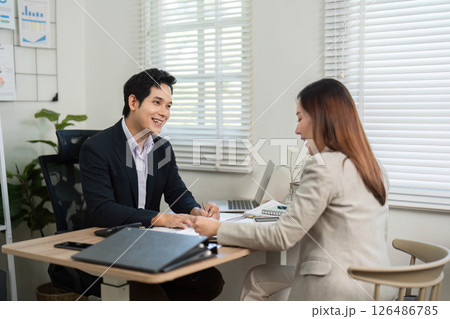 Positive Financial Interaction. Colleagues sharing insights in a vibrant office. 126486785