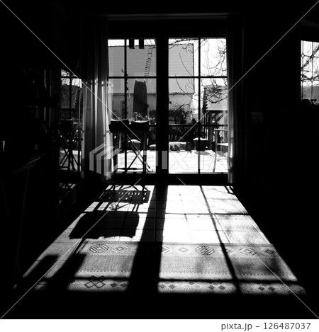 Dark room with a window and a chair 126487037