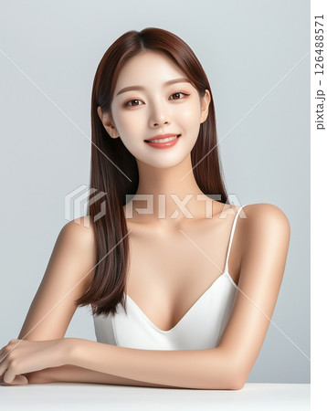 Young Korean woman showcasing natural beauty and glowing skin in a minimalistic setting Young Korean woman showcasing natural beauty and glowing skin in a minimalistic setting 126488571