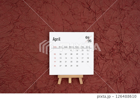 April 2026 calendar on red crumpled paper background. Directly above. April 2026 calendar on red crumpled paper background. Directly above. 126488610