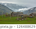 Rustic Mountain Scene with Wooden Houses and Old Car 126488629