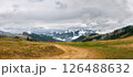 Winding Dirt Road Through Hills Toward Misty Mountains 126488632