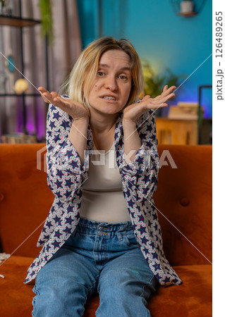 Confused Caucasian woman feeling embarrassed about ambiguous question having doubts no idea clueless 126489265