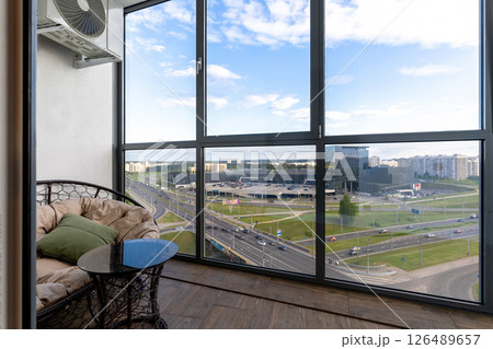 Panoramic City View from Cozy Glass Balcony 126489657