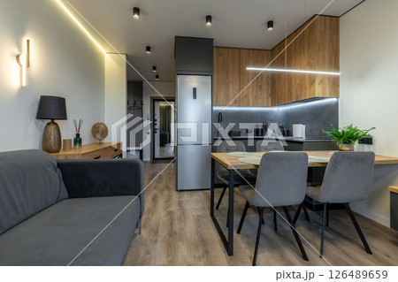 Cozy Open Kitchen and Living Room with Wooden Elements 126489659