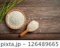 Raw rice in wooden bowl on old wooden table, rice top view. 126489665