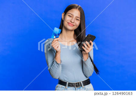 Woman use credit bank card smartphone while transferring spending money, purchases online shopping Woman use credit bank card smartphone while transferring spending money, purchases online shopping 126490163