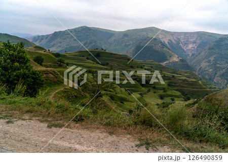 Chokhsky terraces Dagestan. Landscape of mountainous Dagestan with terraced fields and peaks mountains in the distance. 126490859