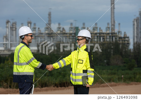 Team engineer worker observes oil refinery at construction site. Survey area energy petrochemical business in Industrial zone. Team engineer worker observes oil refinery at construction site. Survey area energy petrochemical business in Industrial zone. 126491098