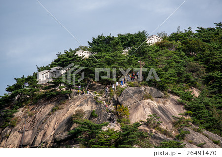 People hike up the old Seoul City Wall in Inwangsan hill, old fortress protecting Seoul, the capital of South Korea 126491470