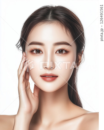 Beautiful Asian woman applying skincare product, showcasing radiant complexion and youthful appearance in a studio setting 126491561