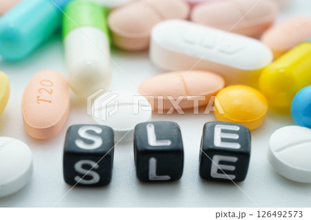 SLE systemic Lupus erythematosus or Lupus word with pills and capsules medical drug. SLE systemic Lupus erythematosus or Lupus word with pills and capsules medical drug. 126492573