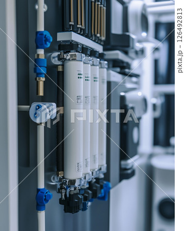 Close up view of a modern water purification system components and details in a controlled environment showcasing filtration technology Close up view of a modern water purification system components and details in a controlled environment showcasing filtration technology 126492813
