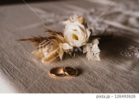 Wedding Rings and Floral Arrangement on Linen Fabric Wedding Rings and Floral Arrangement on Linen Fabric 126493626