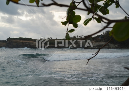 serene beach scene with sand stretching across the foreground 126493934