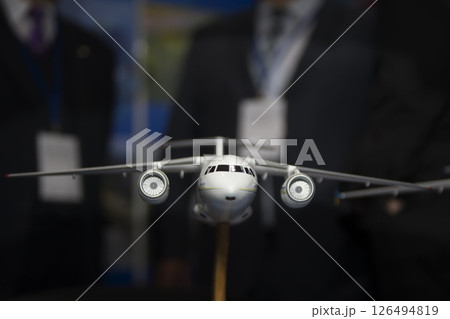 White toy plane on a black background White toy plane on a black background 126494819