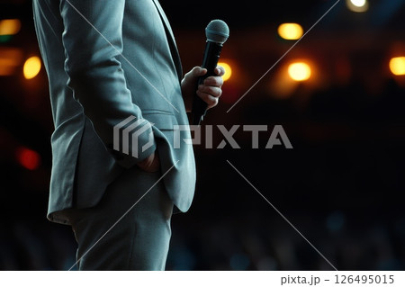 Motivational Speaker Holding Microphone in Close-Up Shot During Engaging Presentation Motivational Speaker Holding Microphone in Close-Up Shot During Engaging Presentation 126495015