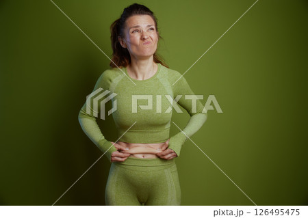 Displeased woman pinching belly fat 126495475