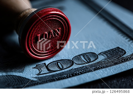 Close-up of a red rubber stamp labeled 'Loan' on a hundred dollar banknote Close-up of a red rubber stamp labeled 'Loan' on a hundred dollar banknote 126495868