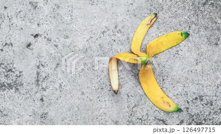 Ripe yellow banana peels on the garden floor, Concept of recycling, safety, education. Ripe yellow banana peels on the garden floor, Concept of recycling, safety, education. 126497715