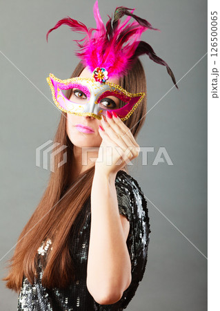 woman face with carnival mask on gray 126500065