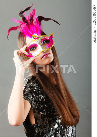 woman face with carnival mask on gray woman face with carnival mask on gray 126500067