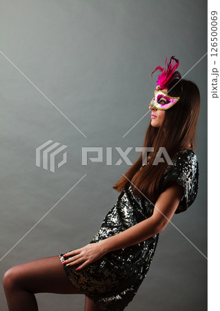 woman with carnival mask on gray woman with carnival mask on gray 126500069