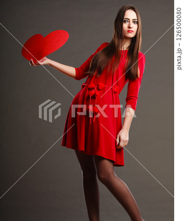Girl holding red heart love sign Girl holding red heart love sign 126500080