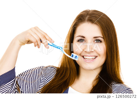 Woman holds toothbrush with paste. Woman holds toothbrush with paste. 126500272