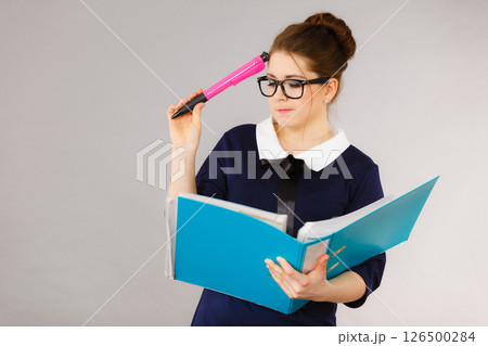 woman thinking holds file folder with documents woman thinking holds file folder with documents 126500284