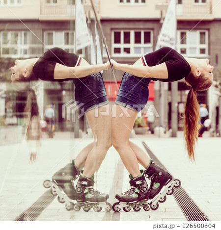 Young woman flexing in roller skates 126500304
