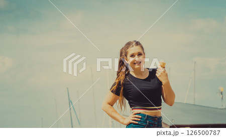 Young woman eating ice cream 126500787