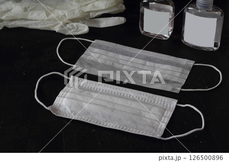 A wedding ring on a medical face mask. Divorce and marriage separation during the Coronavirus A wedding ring on a medical face mask. Divorce and marriage separation during the Coronavirus 126500896