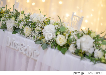 wedding table with exclusive floral arrangement prepared for reception, wedding or event centerpiece in greenery style wedding table with exclusive floral arrangement prepared for reception, wedding or event centerpiece in greenery style 126500996