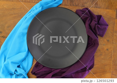 Empty black slate plate on dark stone table. Food background for menu, recipe Empty black slate plate on dark stone table. Food background for menu, recipe 126501293